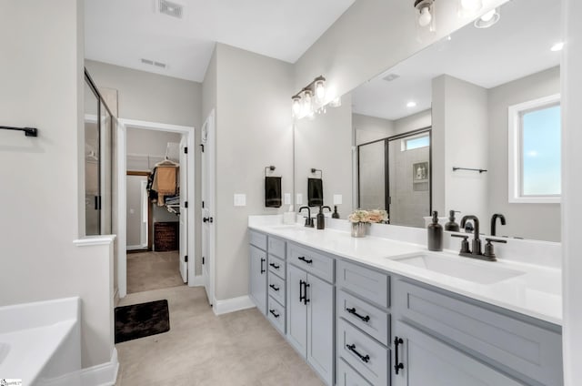 bathroom featuring vanity and separate shower and tub