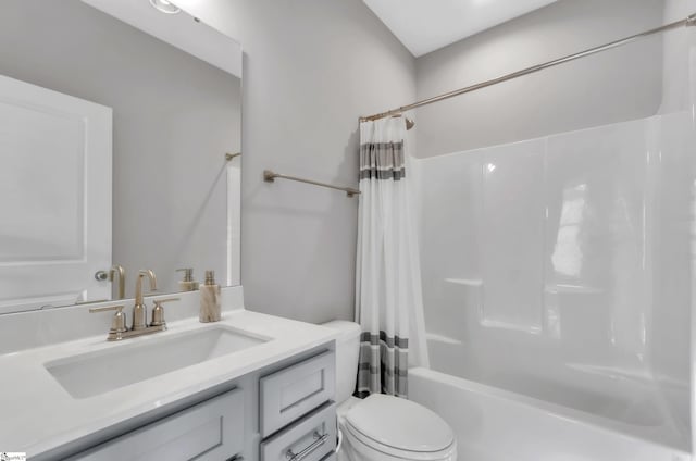 full bathroom featuring vanity, toilet, and shower / tub combo with curtain