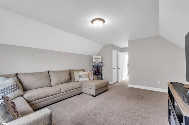 carpeted living room with vaulted ceiling