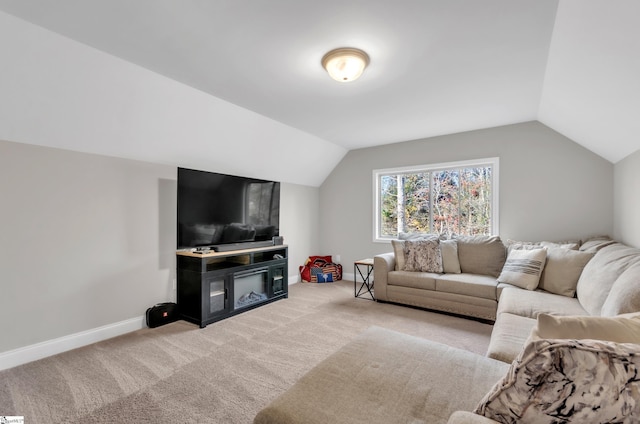 carpeted living room featuring lofted ceiling