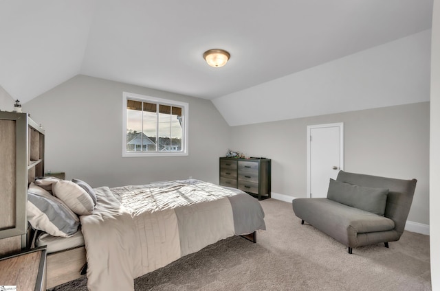 bedroom with lofted ceiling and light carpet