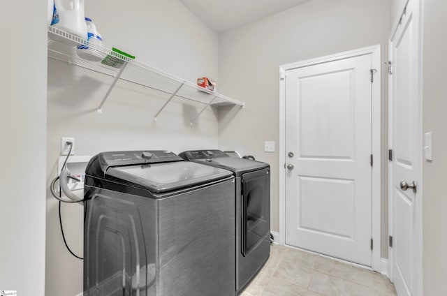 clothes washing area featuring independent washer and dryer and light tile patterned floors