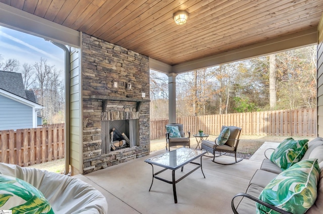 view of patio with an outdoor living space with a fireplace