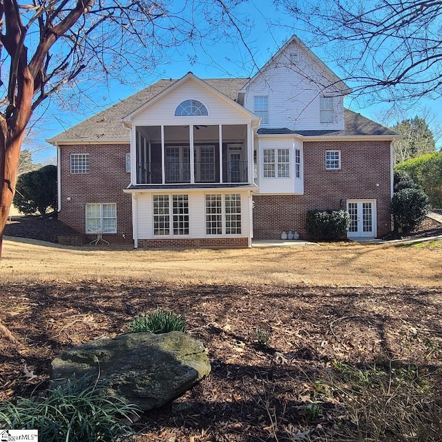 back of property featuring a sunroom and french doors