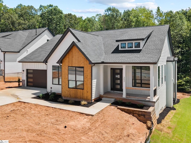 view of front of home with a porch and a garage