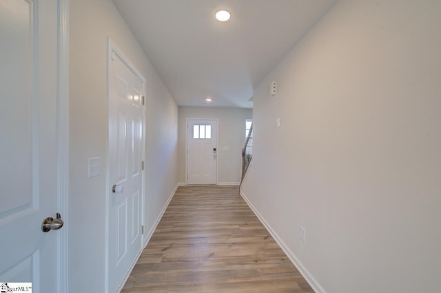 corridor with light hardwood / wood-style flooring