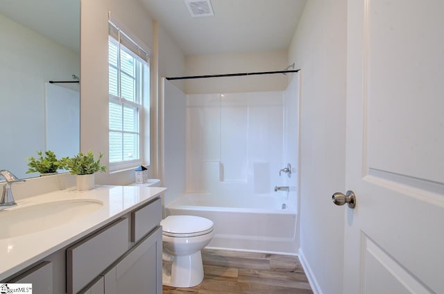 full bathroom with vanity, toilet, wood-type flooring, and shower / tub combination