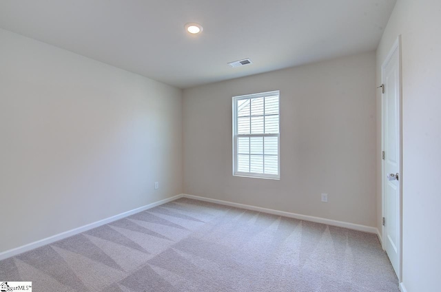 empty room featuring light colored carpet