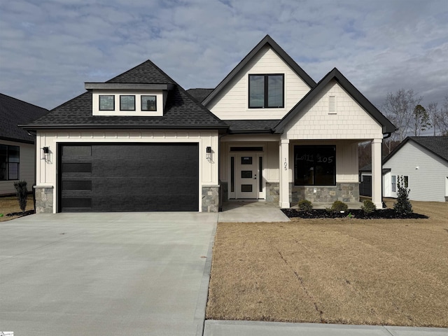 view of front of home with a garage and a front lawn