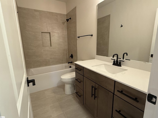 full bathroom featuring tile patterned floors, tiled shower / bath combo, toilet, and vanity