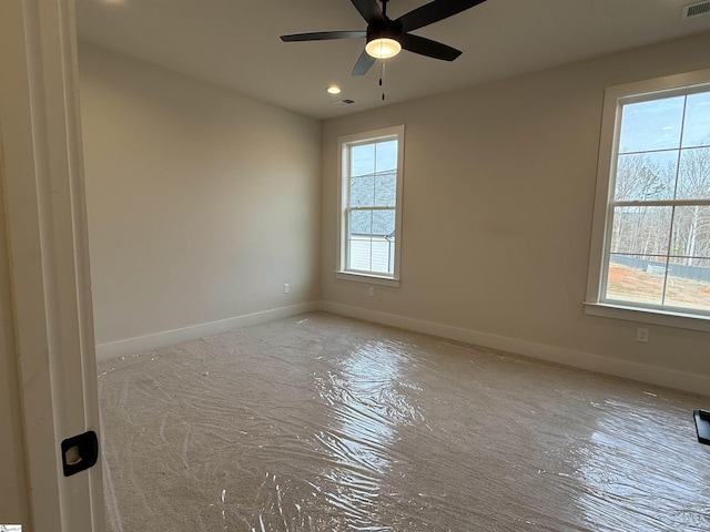 empty room featuring ceiling fan and a healthy amount of sunlight