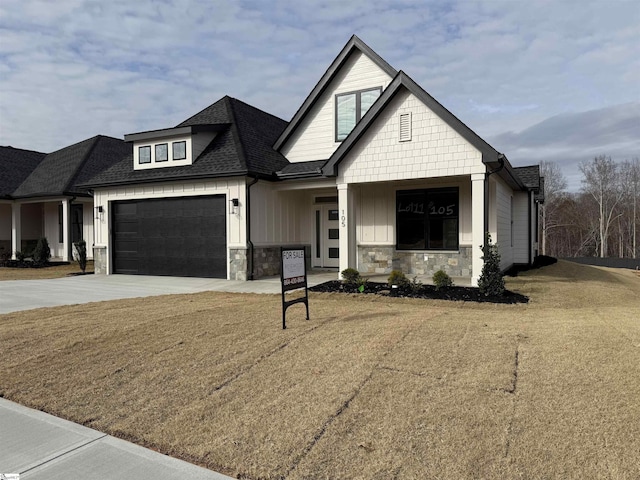 view of front of house with a front yard and a garage