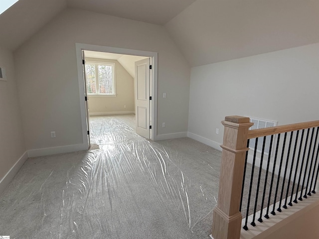 additional living space with light carpet and lofted ceiling