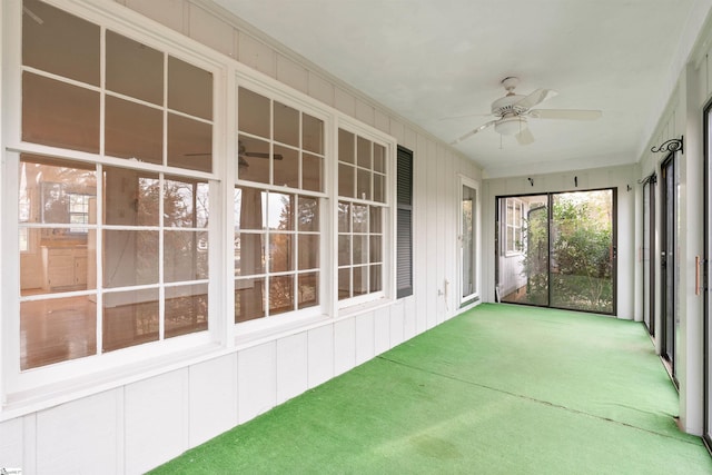 unfurnished sunroom featuring ceiling fan