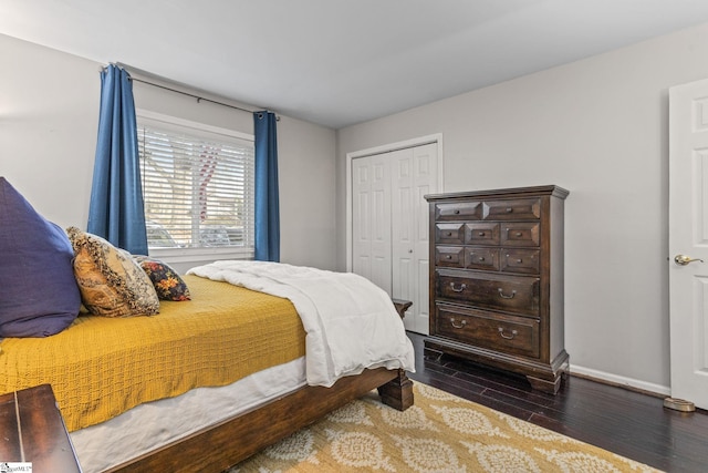 bedroom with a closet and dark wood-type flooring