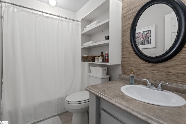 bathroom featuring tile patterned flooring, vanity, and toilet