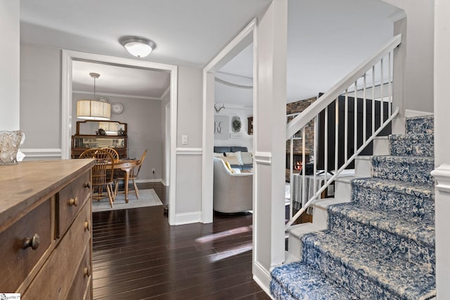 interior space with hardwood / wood-style floors and crown molding