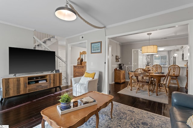 living room featuring dark hardwood / wood-style floors and ornamental molding