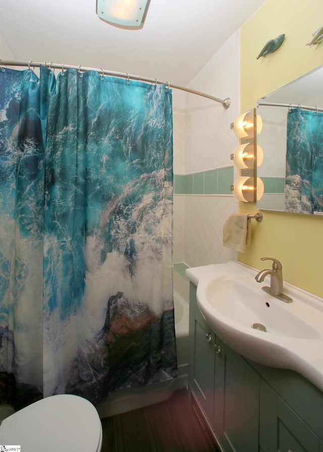 bathroom featuring curtained shower, hardwood / wood-style floors, vanity, and toilet