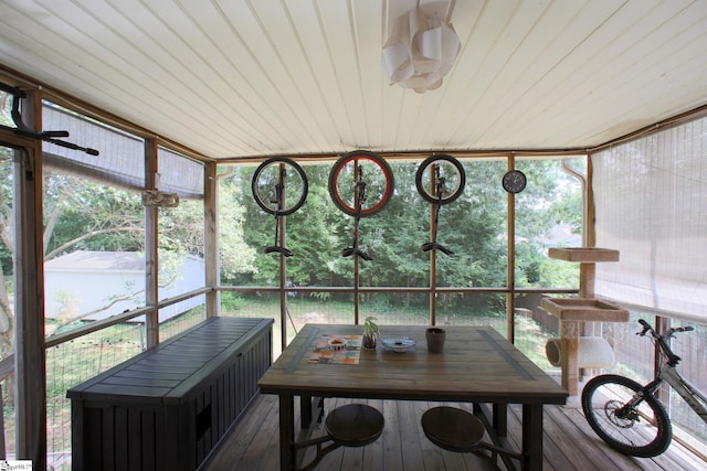 sunroom featuring a wealth of natural light and wood ceiling