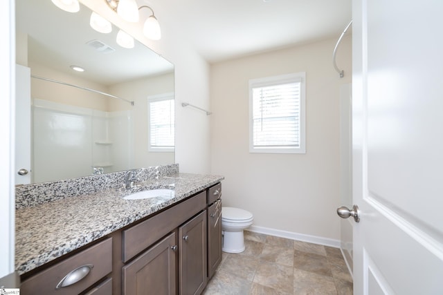 bathroom with a shower, vanity, and toilet