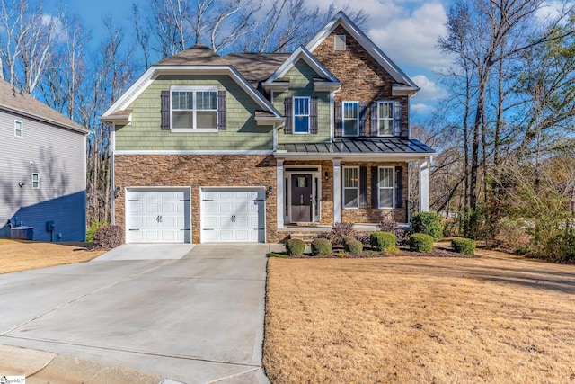 craftsman-style home with central AC, a front lawn, a porch, and a garage