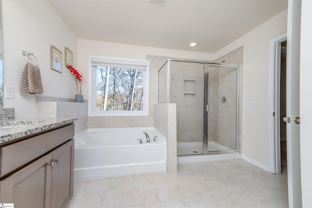 bathroom with vanity and separate shower and tub