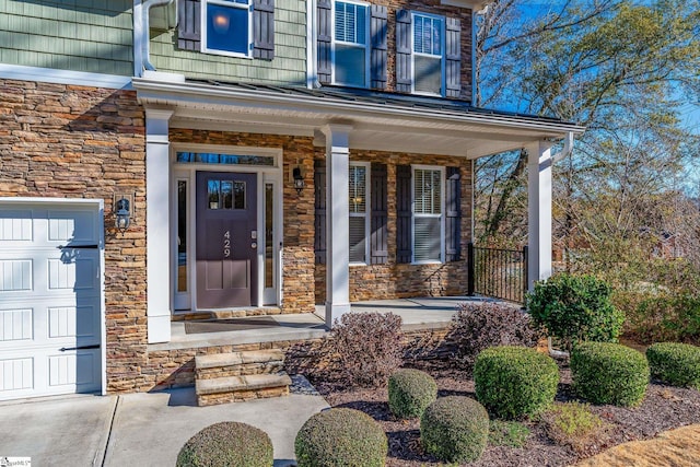 view of exterior entry with a porch