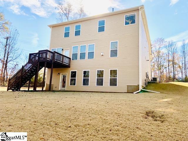 rear view of property with a wooden deck and central AC unit