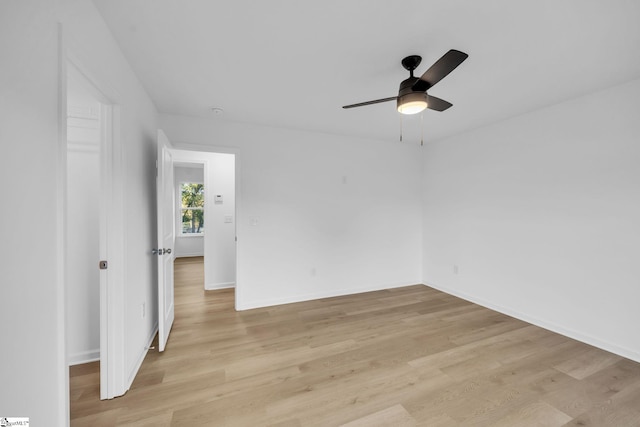 empty room with ceiling fan and light wood-type flooring