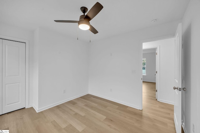 unfurnished bedroom with light wood-type flooring, a closet, and ceiling fan