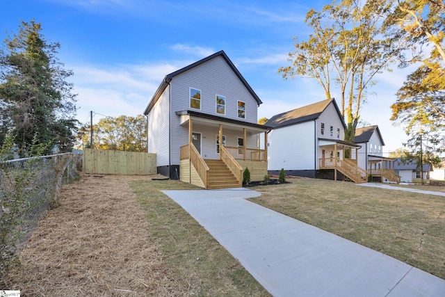 view of front facade with covered porch and a front lawn