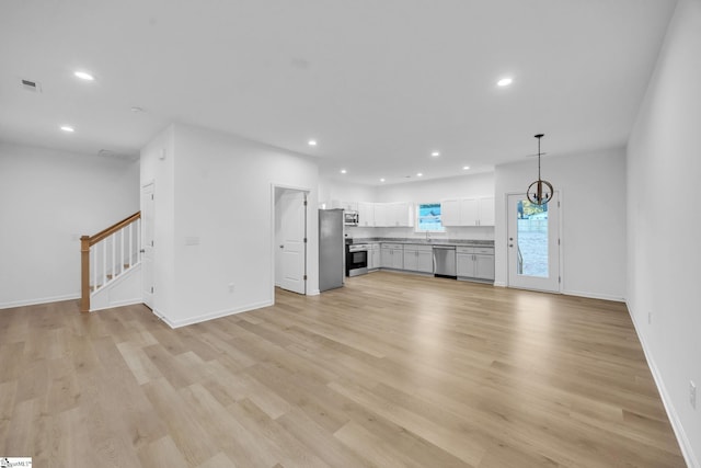 unfurnished living room with light hardwood / wood-style flooring