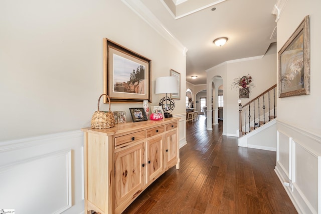 corridor with dark hardwood / wood-style flooring and crown molding