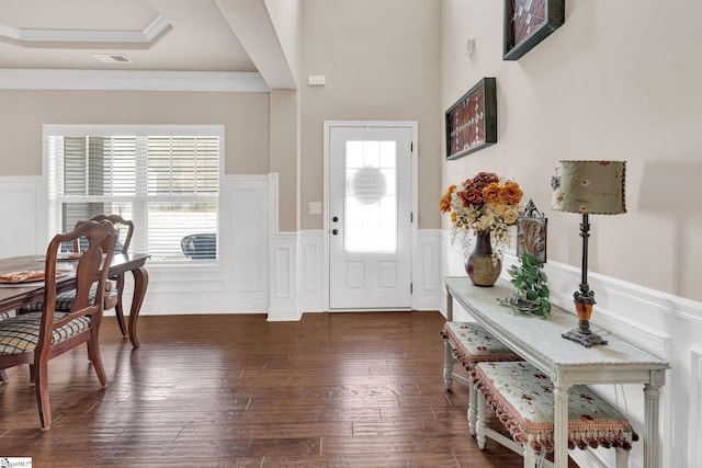 entrance foyer featuring plenty of natural light, dark wood-type flooring, and ornamental molding