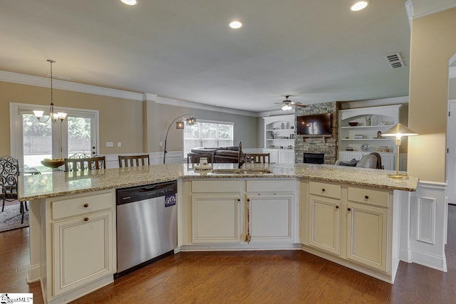 kitchen with light stone countertops, sink, stainless steel dishwasher, and light hardwood / wood-style floors