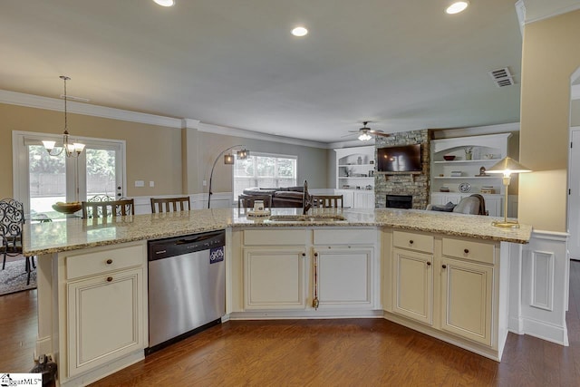 kitchen featuring light stone countertops, light wood-type flooring, stainless steel dishwasher, sink, and pendant lighting