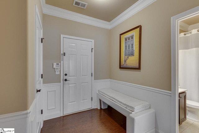 entrance foyer with crown molding and wood-type flooring