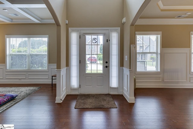 entryway with dark hardwood / wood-style flooring, ornamental molding, a wealth of natural light, and coffered ceiling