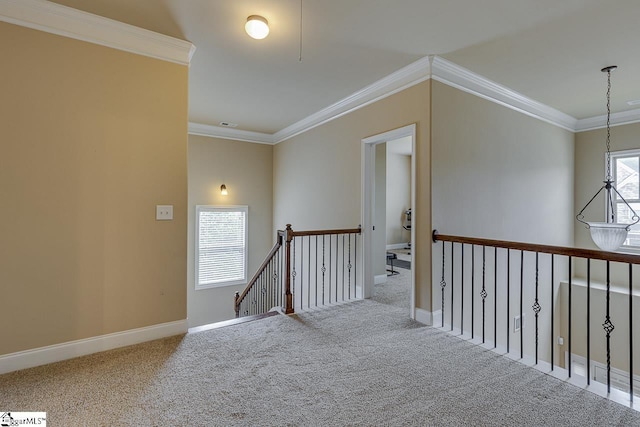 hall with crown molding and light colored carpet