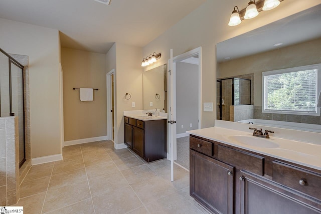 bathroom with tile patterned flooring, vanity, and a shower with shower door