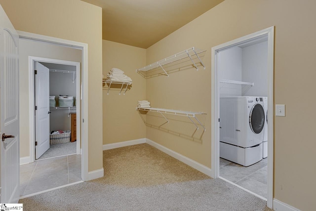 spacious closet featuring light carpet and washer / dryer