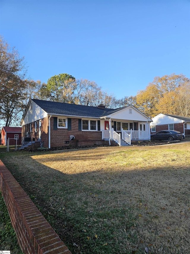 ranch-style house featuring a front yard and a porch