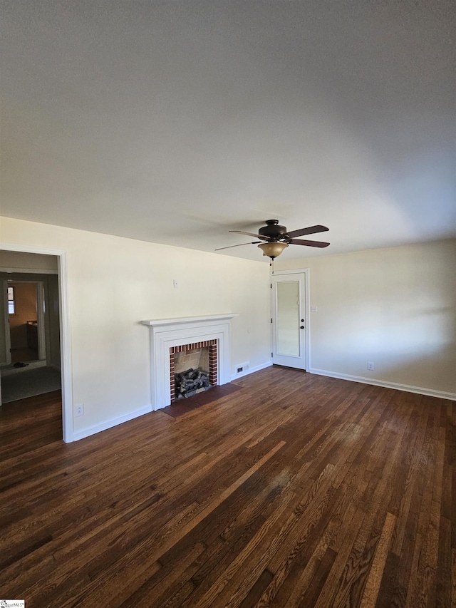 unfurnished living room with a fireplace and dark wood-type flooring