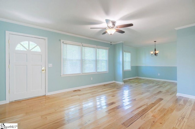 entrance foyer with light hardwood / wood-style flooring, ceiling fan with notable chandelier, and ornamental molding