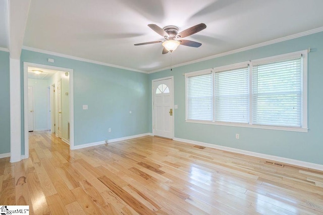 entryway with ceiling fan, light wood-type flooring, and crown molding