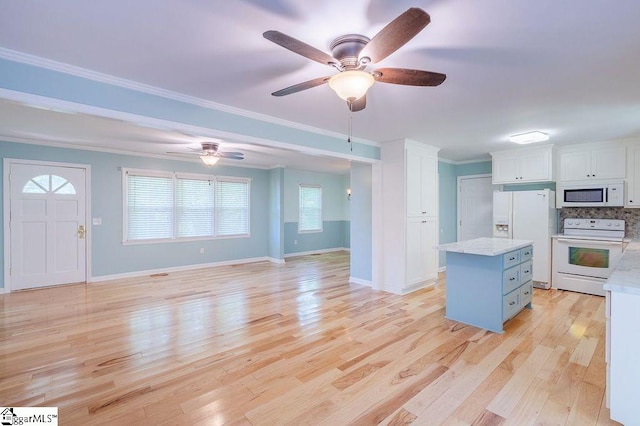 kitchen featuring white cabinetry, a kitchen island, light hardwood / wood-style floors, and white appliances