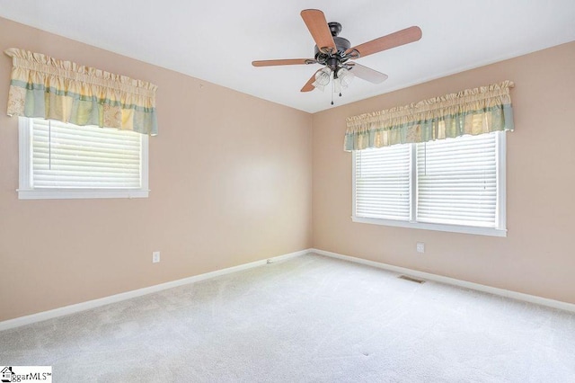 unfurnished room with carpet, ceiling fan, and a healthy amount of sunlight