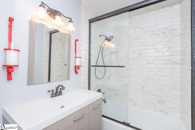 bathroom featuring shower / bath combination with glass door and vanity