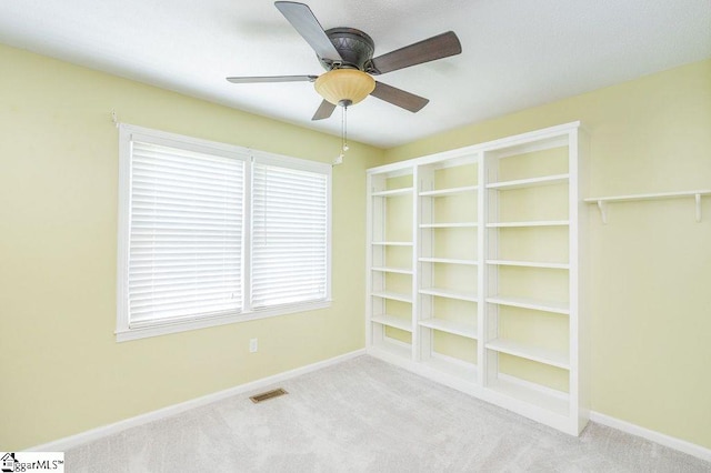 unfurnished room with ceiling fan and light carpet